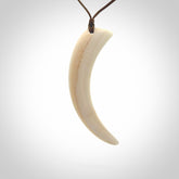 Hand carved incredible Huia bird beak bone carving. A stunning work of art, beautifully replicating a hula bird beak. This pendant was hand carved in bone by artist Yuri Terenyi. A one off pendant that has been hand crafted to be worn.